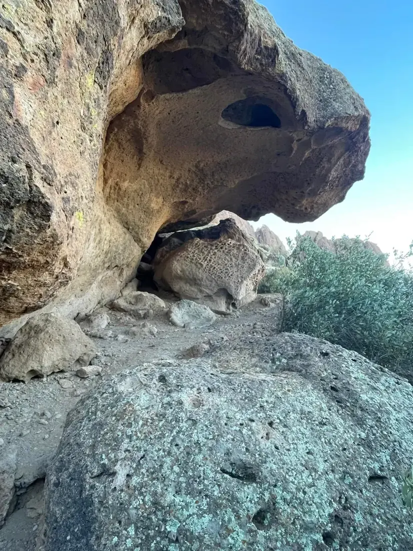 Hiker under a rock overhang in the Superstitions
